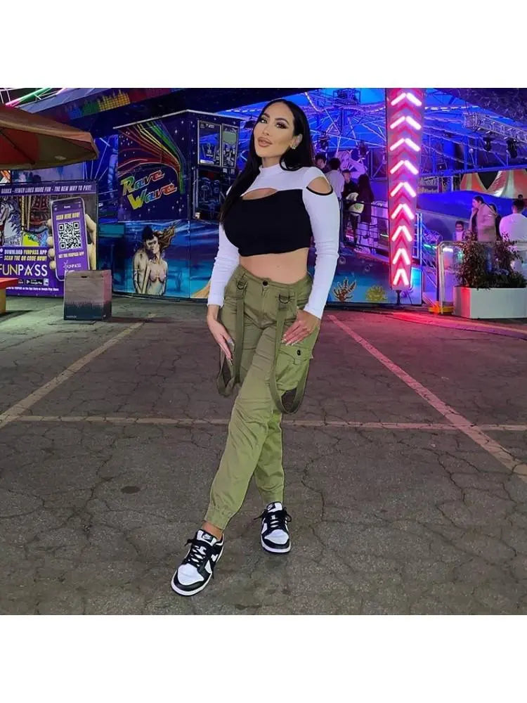 Trendy Getter Strappy Cargo Pants worn by a woman at an amusement park.