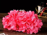 Floral Princess Clutch Handbag with elegant pink flower design on a wooden table, perfect for any occasion.