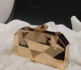 Gold geometric Reflections Clutch on white fabric.