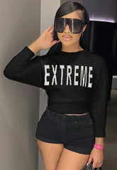 Extreme cropped sweater with bold "EXTREME" lettering, paired with high-waisted shorts.