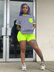 Trendy striped top and neon biker shorts set for women.