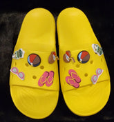 Yellow sporty chill slides with decorative charms.