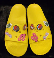 Yellow sporty chill slides with decorative charms.