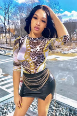 Sheer Royalty Mesh Bodysuit modeled outdoors with stylish prints and chains.