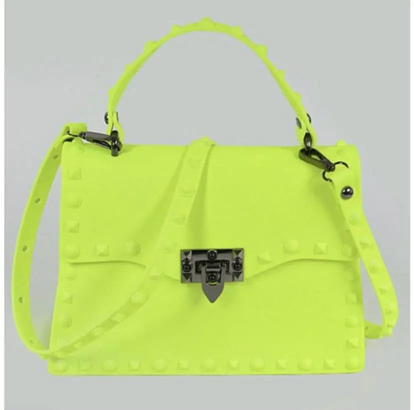 Bright yellow crossbody statement handbag with stud details.