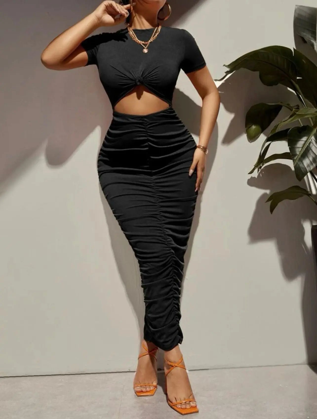 Stylish black bodycon maxi-dress with cut-out design.