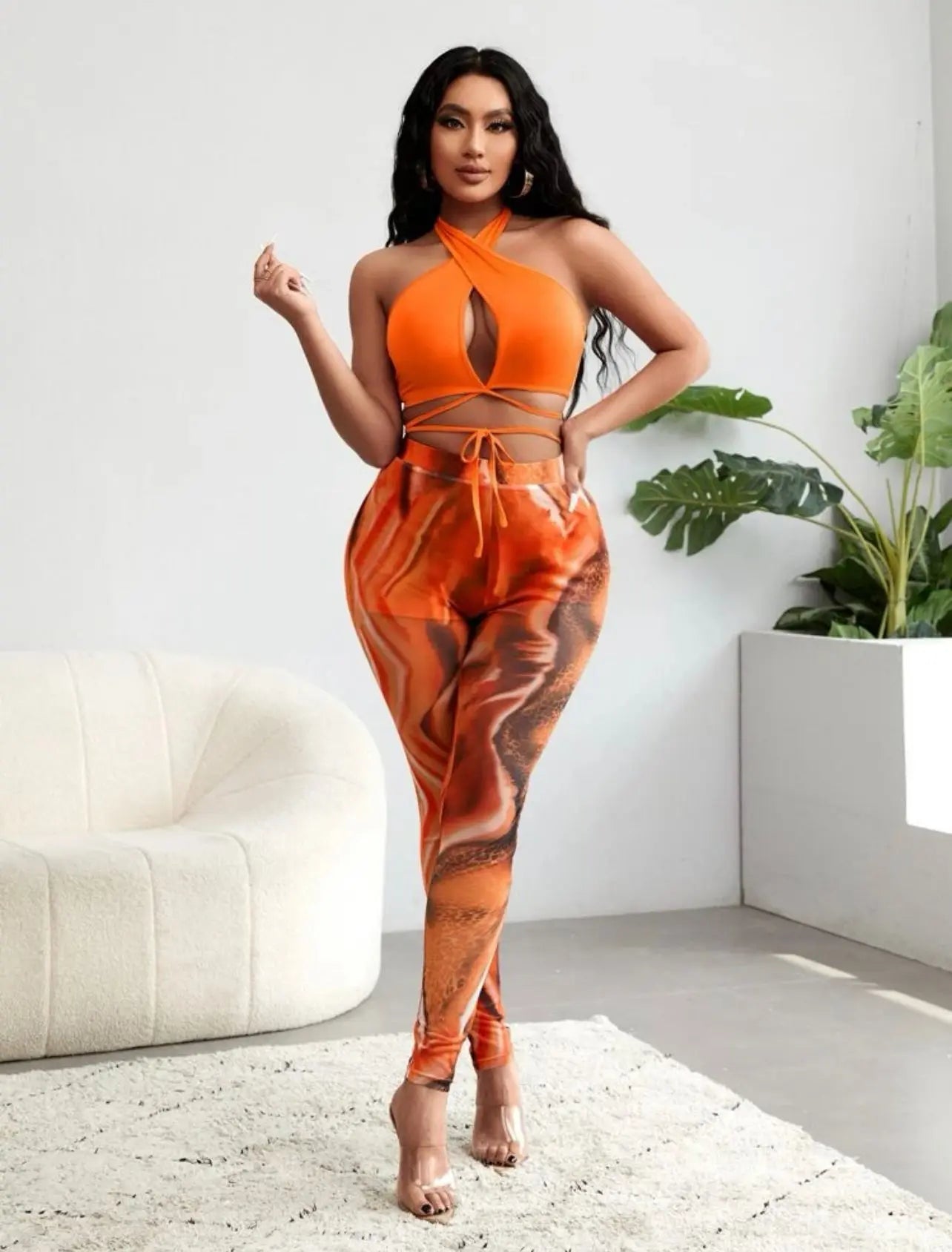Stylish 2-piece halter top and tights from Assignment Understood Set in vibrant orange.