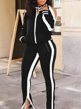 Black and white women's tracksuit set with stripe detail, ideal for athleisure style.