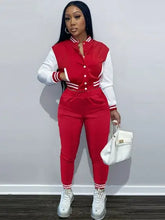 Women's trendy red tracksuit pants set with white accents.