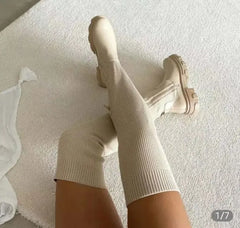 Thigh high beige knitted boots with thick soles for women.