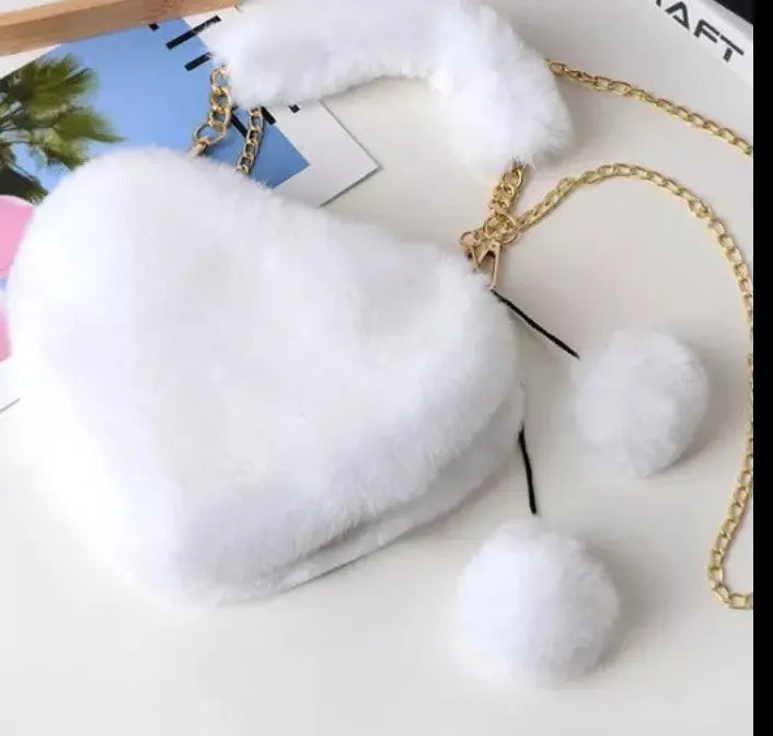 Image & Stylez LLCLove Fuzzy Heart HandbagColor My Love Fuzzy Heart HandbagThis stylish plush handbag is designed with fluffy fur outside. It has a fuzzy top handle and one golden chain shoulder strap that is removable. There are 3 differen