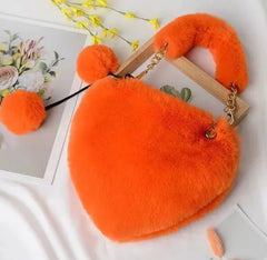 Image & Stylez LLCLove Fuzzy Heart HandbagColor My Love Fuzzy Heart HandbagThis stylish plush handbag is designed with fluffy fur outside. It has a fuzzy top handle and one golden chain shoulder strap that is removable. There are 3 differen