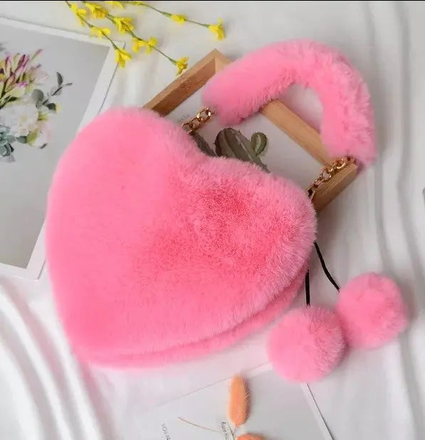 Image & Stylez LLCLove Fuzzy Heart HandbagColor My Love Fuzzy Heart HandbagThis stylish plush handbag is designed with fluffy fur outside. It has a fuzzy top handle and one golden chain shoulder strap that is removable. There are 3 differen
