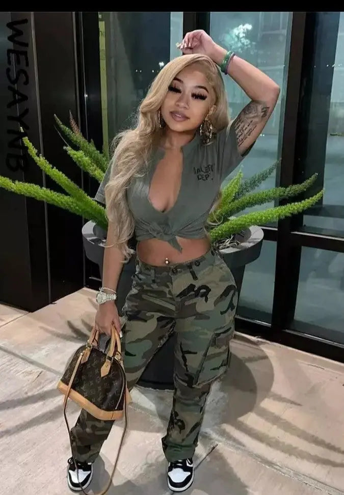 Women wearing camo cargo pants standing outdoors.