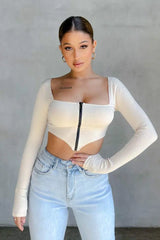 Ribbed zip up top in cream with full sleeves and front zipper detail.