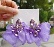 Purple Sheer & Dazzle Earrings with floral design and sparkling gemstones.