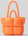 Fun & Futuristic Puffy Handbag in vibrant orange puffed fabric with double handles.